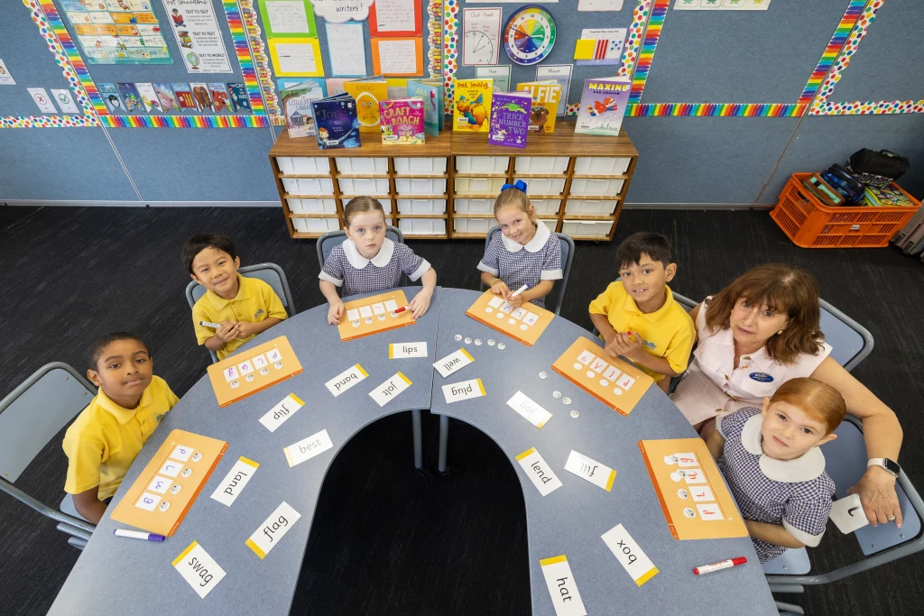 Students at Bethany Catholic Primary School in Werribee North practise their phonics skills with principal Joanne Webster.Credit: